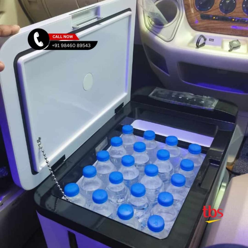 15 In-car cooler filled with bottled water, ready for passengers, with a nearby control panel and a blue-lit cabin area.