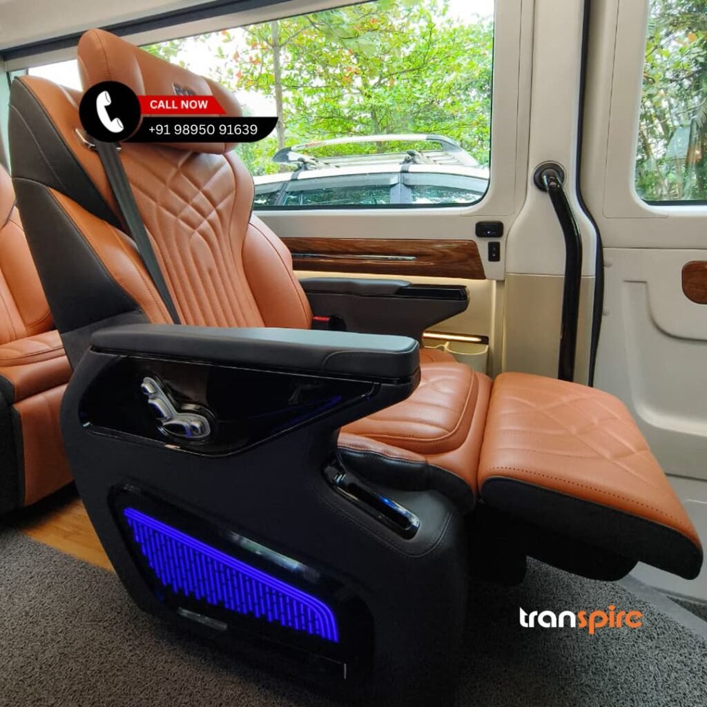 Ultra Luxury Urbania Rental Kochi Luxurious orange quilted leather captain's seat with adjustable armrest and blue ambient lighting in a van interior, Transpire branding visible.